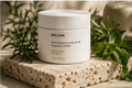 White jar of 'Willow' deep cleanse scalp scrub on a stone surface with green plants. Rosemary, healthy scalp and mint ingredients used in Willow Deep Cleanse Scalp Scrub Rosemary & Mint. Willow Deep Cleanse Scalp Scrub Rosemary & Mint luxury hair care treatment for scalp exfoliation and buildup removal. Formulated with natural exfoliants, strengthening Keratin, nourishing Shea Butter, and revitalizing Rosemary and Peppermint Oils, this purifying scrub helps lift away excess oil, impurities, and flakes while