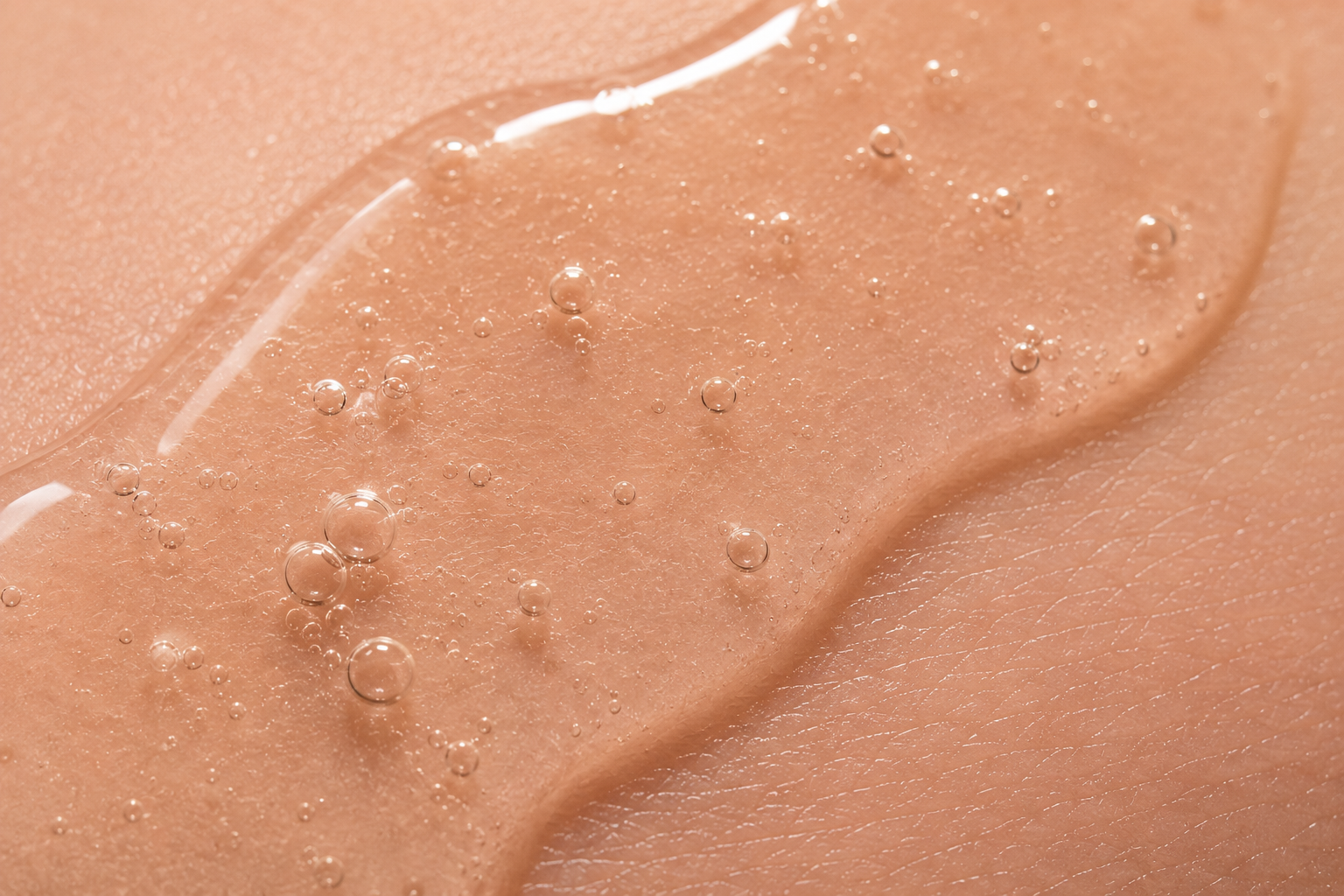 Close-up of AHA exfoliating serum texture with glossy gel and micro bubbles representing gentle chemical exfoliation and skin renewal.